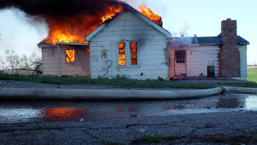 A home in flames, owned by a homeowner who did not learn. how to prevent house fires
